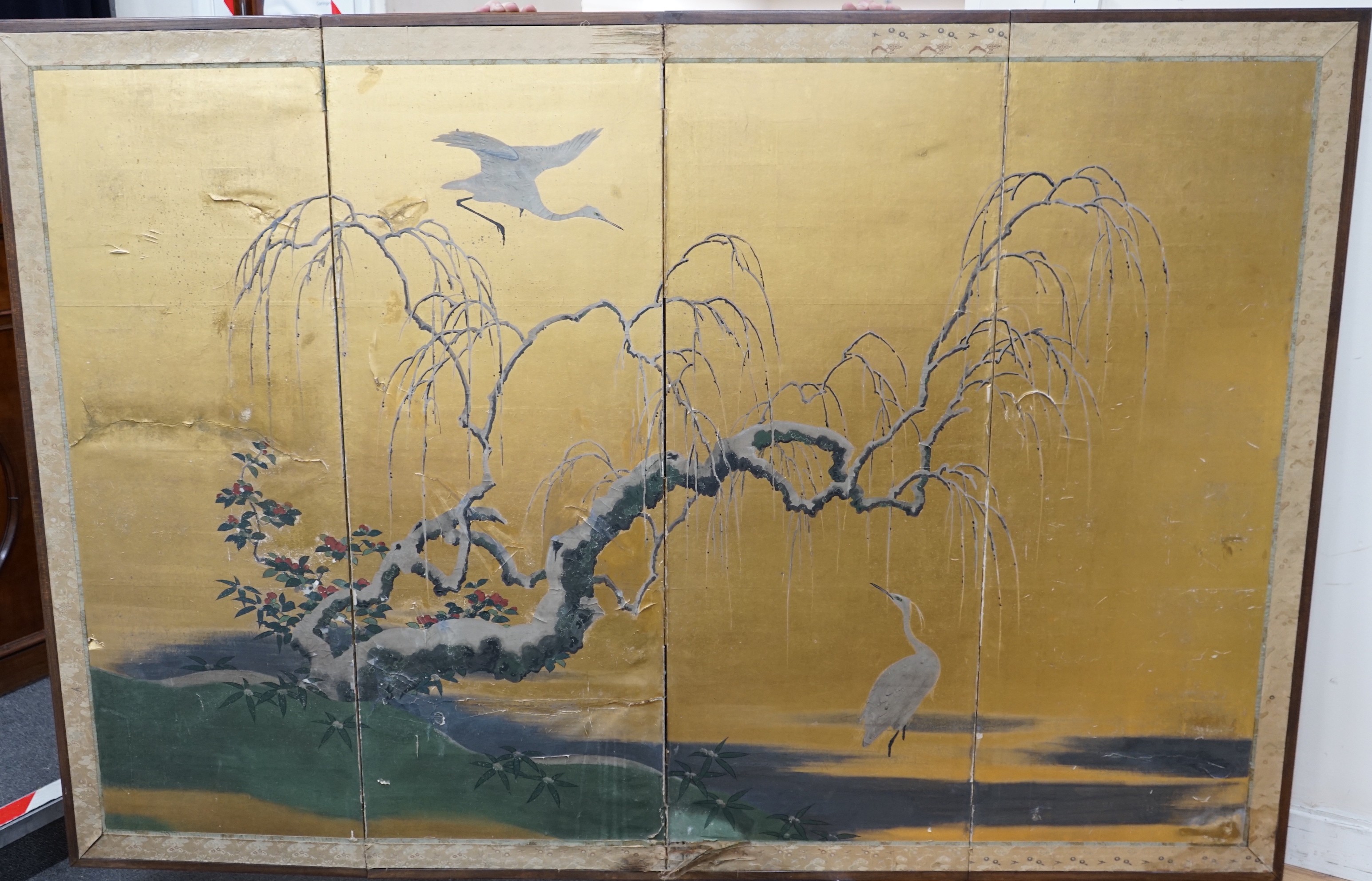 A Japanese four fold screen painted with a Crane above a Prunus tree now fixed as a wall panel, 184cms x 125cms.